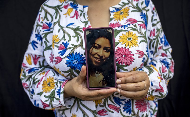 A female member of the Xinka community displays an image of Topacio Reynoso Pacheco, who was murdered in 2014
