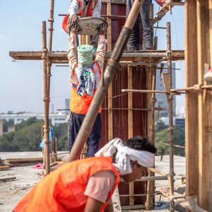 Construction workers high rise building Delhi, India
