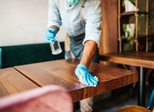 Restaurant server cleans table