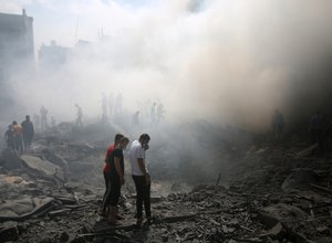 Palestinians look for survivors after an Israeli airstrike in Rafah refugee camp, southern Gaza Strip, on October 12 2023.